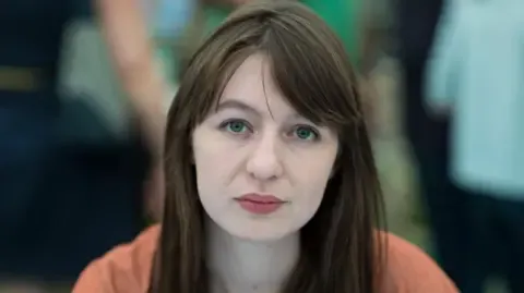 The acclaimed novelist declares she is unable to travel to the UK due to arrest fears